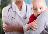 parent and baby with doctor