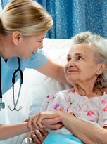 nurse assisting elderly woman