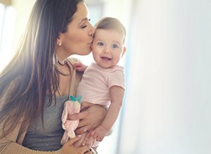 mommy kissing baby